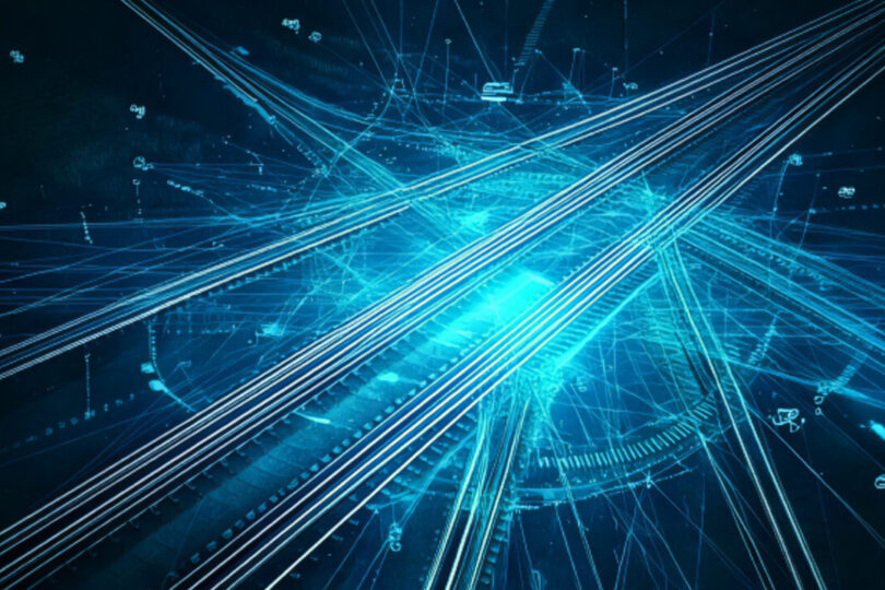 Futuristische Schienen, die sich vor einem blauen Neonhintergrund kreuzen.